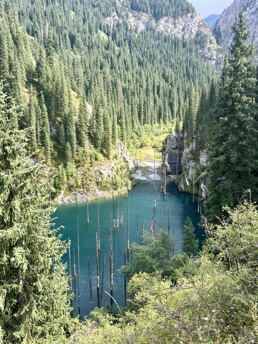 Turquoise Kaindy Lake and its sunken forest in the mountains of Kazakhstan